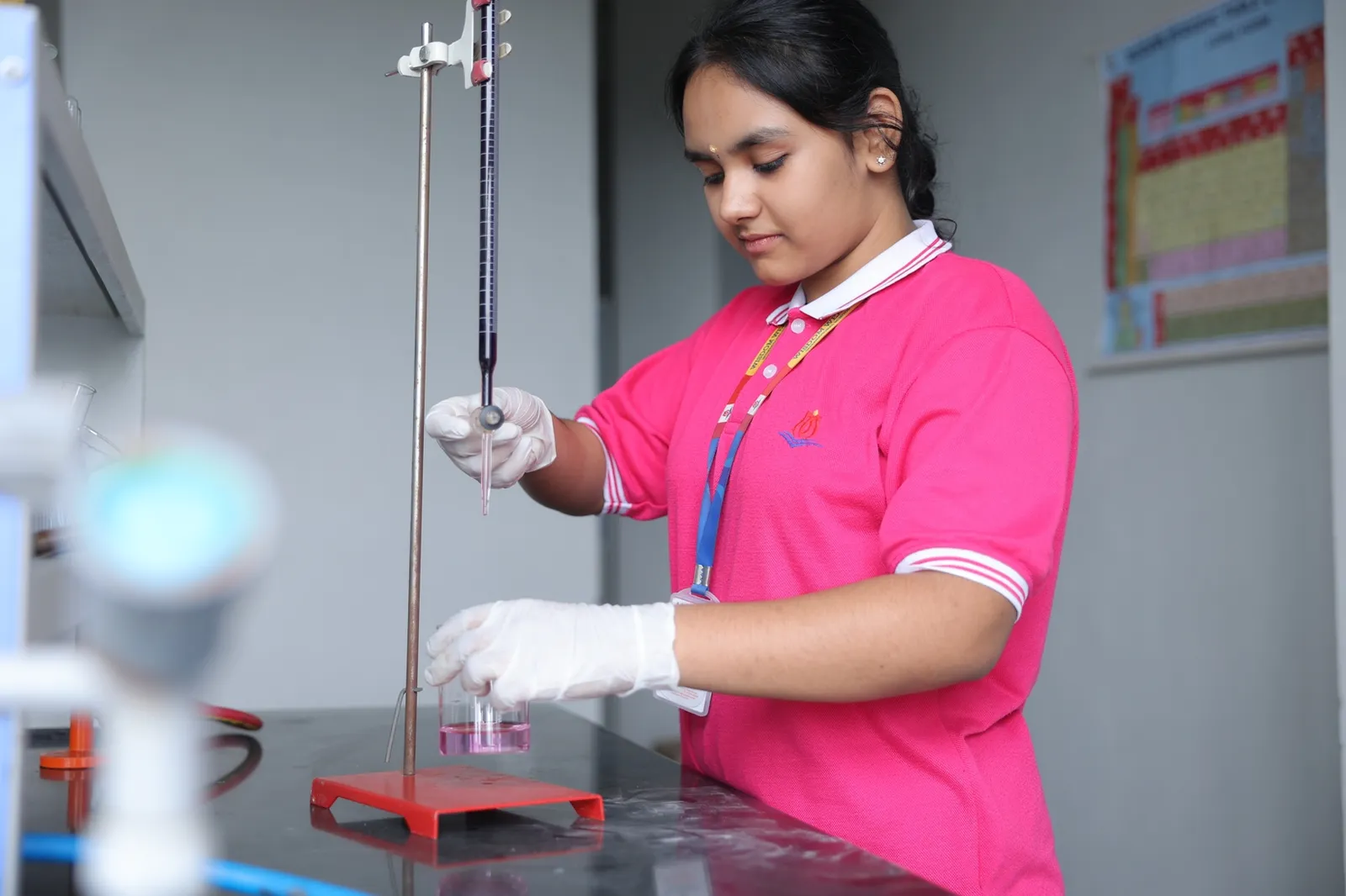 Student performing a titration in the chemistry lab