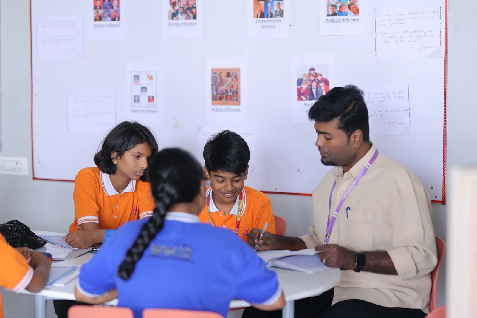 Teacher mentoring a small group of students